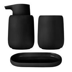 two black soap dispensers sitting next to each other on a white surface