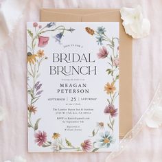 a floral bridal brunch party is set up on a pink tablecloth