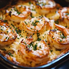 a close up of a pan of food with shrimp on it and garnished in parsley