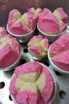 several bowls filled with pink and white desserts sitting on top of a metal pan