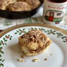 a piece of pie on a plate next to a cup of tea and a cookie