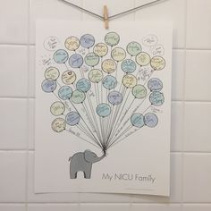 an elephant holding balloons with the words my nicu family written on it and attached to a wall