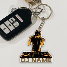 a car keychain with a dj sticker on it and a pair of keys