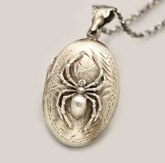 "A sterling silver picture locket featuring a stunning spider on the front. This gothic style necklace is an oval locket with a working compass inside and a place for your favorite photo. Instead of a photo you could take it to a jeweler and have something engraved on the inside. A mini working brass compass with glass top is set in an antiqued sterling silver crown edge bezel. The working compass is set inside a .925 sterling silver locket. On the front of the sterling silver locket necklace is Antique Silver Locket Necklace With Charms, Silver Gothic Locket Jewelry, Silver Antique Locket Necklace With Charms, Unique Engraved Locket Necklace Collectible, Locket For Men, Whimsigoth Jewelry, Compass Necklace Silver, Sterling Silver Locket Necklace, Sterling Silver Spoon Ring