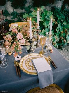 a table set with place settings and candles