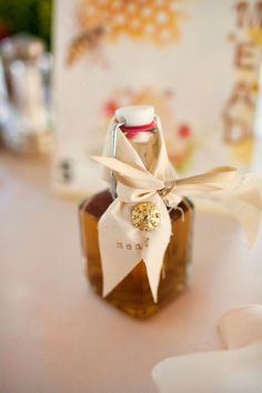 a bottle with a bow on it sitting on a table