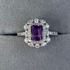 Details: Materials: Amethyst Gemstone, White Zircons, S925 Sterling Silver Plated with 18K White Gold Color: Purple Shape: Retangular Size: Adjustable and fitable for all Descriptions: This elegant ring has a 7x5mm amethyst and forty-four white zircons. Other than the stones, the ring is made out of S925 sterling silver plated with 18K white gold. A ring of small zircons outlined the amethyst. A circle zircon alternates with an oval zircon to create a pattern for the second outline of the ring. Formal Cluster Jewelry With Gemstone Accents, Exquisite Anniversary Gemstones With Halo Setting, Amethyst Cluster Gemstone Jewelry, Fine Jewelry Gemstones With Accents For Anniversary, Anniversary Diamond Gemstones With Gemstone Accents, Amethyst Gemstones With Halo Setting For Anniversary, Exquisite Cubic Zirconia Gemstones For Anniversary, Cluster Gemstones With Accent Stones As Gift, Exquisite Gemstones With Halo Setting For Gift