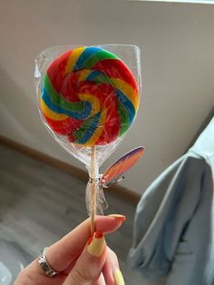 a person holding a lollipop in their hand