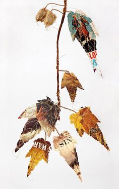 dried leaves hang from a twig with the word love written on them and an american flag painted on it