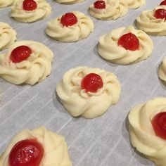 there are many small cookies with jelly on them in the baking pan, ready to go into the oven