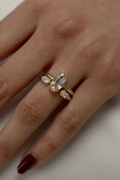 a woman's hand with a ring on it and a diamond in the middle