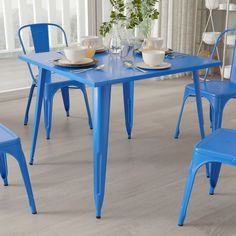 a blue table and chairs in a room