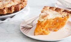 a piece of pie sitting on top of a white plate next to a pie dish