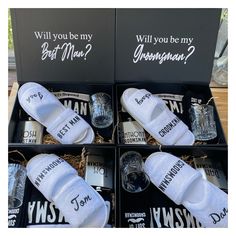 four black boxes with white socks in them and one box has wine glasses inside it