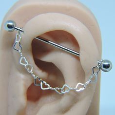 a fake ear with some metal balls attached to it