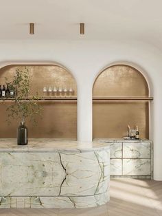 an elegant bar with marble counter tops and gold accents