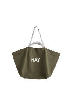 HAY's Weekend bag is a carefree companion for summery trips to the beach or a grocery haul. The large canvas tote has a clever pocket on each end for keeping smaller items within reach. Two sets of handles in different lengths make the Weekend bag easy to carry: let it hang on your shoulder or just grab it and go. Perfected with HAY’s logo, the cotton bag is also perfect for organizing – use it as a laundry bag or as storage for kids' toys, for example. Summer Khaki Beach Bag For Daily Use, Large Capacity Khaki Beach Bag For Travel, Khaki Large Capacity Beach Bag For Travel, Summer Khaki Tote Beach Bag, Everyday Khaki Shoulder Bag For Summer, Summer Everyday Khaki Shoulder Bag, Summer Beach Bag With Pockets For Everyday, Cotton Weekender Bag For Summer Travel, Summer Tote Weekender Bag