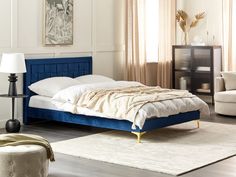 a blue bed with white sheets and pillows