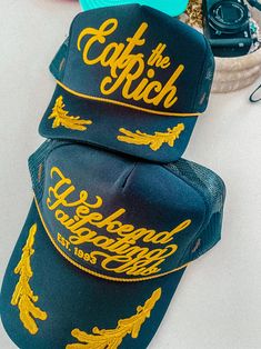 Show off your vibes in our new 90's inspired Eat The Rich trucker hat.- Features the phrase "Eat The Rich" all in a gold puff ink - Comes with a small detachable pin on each hat - Individually heat pressed onto each hat- 5 Panel, Mesh Back with Snap Back*due to screens & filters colors may vary slightly to photos* Graphic Baseball Cap, Futch Style, Street Wear Hats, Merch Ideas Products, Artist Merch, Hat Inspiration, Streetwear Hats, 90s Sports, Eat The Rich