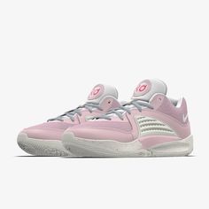 a pink and white tennis shoe on a white background with the word nike written across the upper part of the shoe