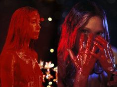 two women covered in red paint standing next to each other