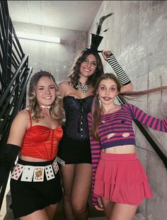 three women dressed in costumes posing for the camera