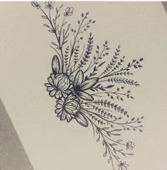 a drawing of flowers and leaves on a piece of paper that has been drawn with ink