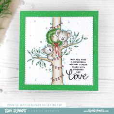 a card with two koalas hugging on a tree