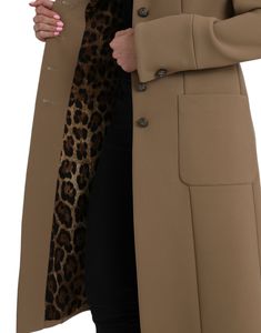 This brown Dolce & Gabbana coat boasts a button down design and is crafted from a blend of 53% polyester, 43% virgin wool, and 4% elastane. It also features a luxurious 92% silk and 8% elastane lining and is made in Italy.   Model: Coat jacket  Color: Brown  Material: 53% Polyester, 43% Virgin Wool, 4% Elastane  Lining: 92% Silk 8% Elastane  Button closure  Made in Italy Tailored Brown Outerwear With Hidden Button Closure, Brown Tailored Outerwear With Hidden Button Closure, Chic Tailored Outerwear With Buttons, Tailored Fall Outerwear With Covered Buttons, Chic Outerwear With Covered Buttons And Lapel Collar, Chic Outerwear With Lapel Collar And Covered Buttons, Tailored Outerwear With Covered Buttons For Fall, Fall Business Outerwear With Covered Buttons, Luxury Office Outerwear With Button Closure