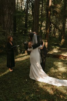 the bride and groom are getting married in the woods