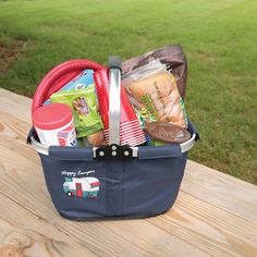 a picnic basket sitting on top of a wooden table