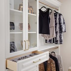 the closet is organized with clothes and leopard print bags, shoes, and handbags