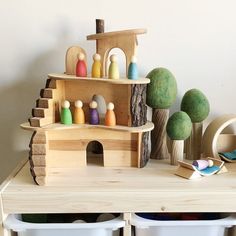 a wooden toy house sitting on top of a table