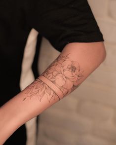 a person with a flower tattoo on their arm