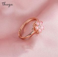 Capture the essence of cherry blossom season with our Silver Sakura Spinner Ring. This elegant piece tells a story of beauty and renewal, as delicate petals bloom and dance in the breeze. The spinner design allows for a soothing sensation, perfect for those seeking balance and serenity in their daily lives. Elevate your style with this stunning symbol of hope and new beginnings.   - Brand: Thaya  - Material: S925 Silver  - Weight : About 2.34g  - Size: Stack Mouth 14th  - Style: Flower  - Gender: Women Spring Wedding Rose Gold Jewelry, Spring Rose Gold Flower Jewelry, Spring Wedding Jewelry With Petal Design, Rose Gold Jewelry For Anniversary In Spring, Rose Gold Jewelry For Spring Anniversary, Delicate Jewelry For Anniversary In Spring, Delicate Jewelry For Spring Anniversary, Rose Gold Ring For Spring, Spring Rose Gold Ring Jewelry