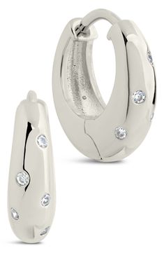 Brightly polished hoops are highlighted further by round-cut cubic zirconia that lend a dose of shine to any ensemble. 0.6" hoop diameter; 0.2" width Hinge with snap-post closure Rhodium plate/cubic zirconia
 Imported Modern Round Cubic Zirconia Huggie Earrings, Modern Small Hoop Cubic Zirconia Earrings, Modern White Gold Huggie Earrings With Cubic Zirconia, Modern Cubic Zirconia Small Hoop Earrings, Modern Huggie Earrings In Diamond White Cubic Zirconia, Modern Channel Set Cubic Zirconia Earrings, Modern Diamond White Cubic Zirconia Huggie Earrings, Modern Cubic Zirconia Hoop Earrings In Diamond White, Modern Small Hoop Earrings With Diamond Accents