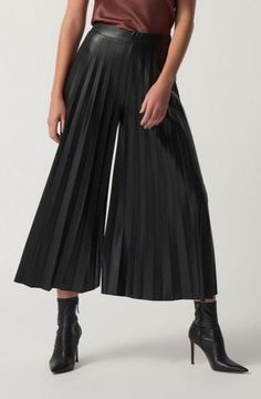 These culotte pants are the epitome of chic. The unique pleated leather-look fabric is luxurious and slimming, while the covered elastic waistband ensures a comfortable, flattering fit. These statement-making pants flow beautifully, making them perfect for a night out or a day at the office. DETAILS & CARE 68% Polyester, 26% Polyurethane, 6% Spandex Faux-leather fabric Covered elastic waistband Unlined Hand wash in cold water with like colors Making Pants, Office Details, Day At The Office, Culotte Pants, Charitable Organizations, Joseph Ribkoff, Faux Leather Fabric, Pant Style, Leather Fabric