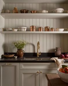 the kitchen is clean and ready for us to use it's counter tops are lined with dishes