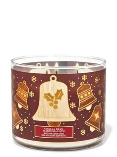 a candle with bells and snowflakes on it