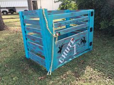 a blue wooden crate sitting in the grass