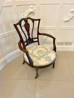 an old chair sitting in the corner of a room with white walls and flooring