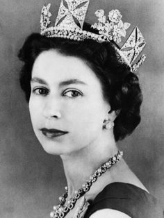 an old black and white photo of a woman wearing a tiara