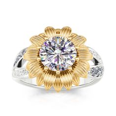 a yellow and white gold ring with a flower design on the center, surrounded by diamonds