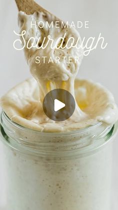 a spoon full of sour cream sitting in a jar