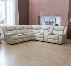 a white leather sectional sofa in a living room