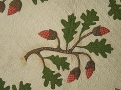 a quilt with leaves and acorns on it