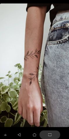 a woman's arm with a small tattoo on the left side of her wrist