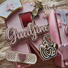 some pink and white items are laying on a furnishing area, with the word glyphine written in large letters