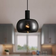 a black light fixture hanging from a kitchen ceiling