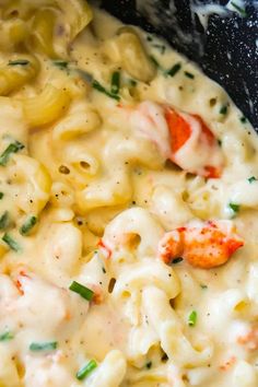 pasta with shrimp and cheese in a black pot